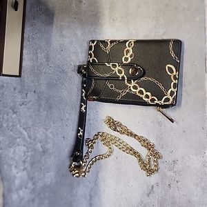 Black and gold card carrier on a chain.